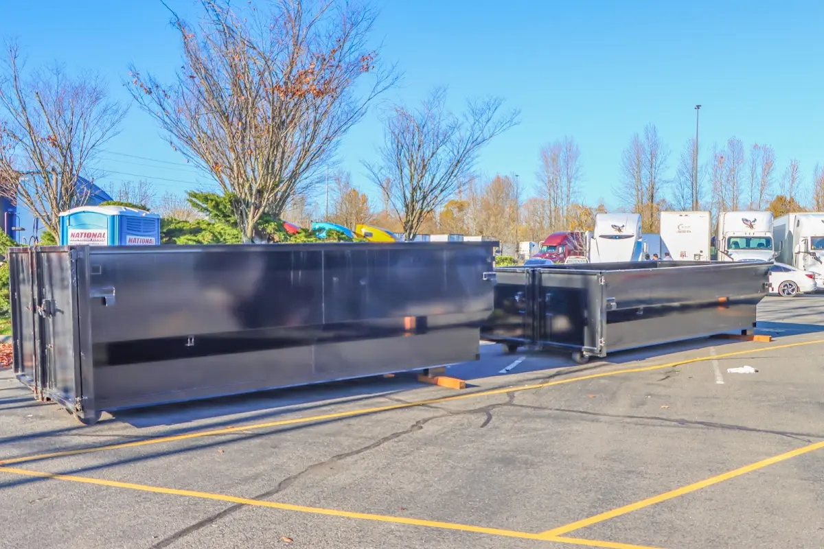 Professional dumpster rental service with roll-off container on residential driveway in Ramona